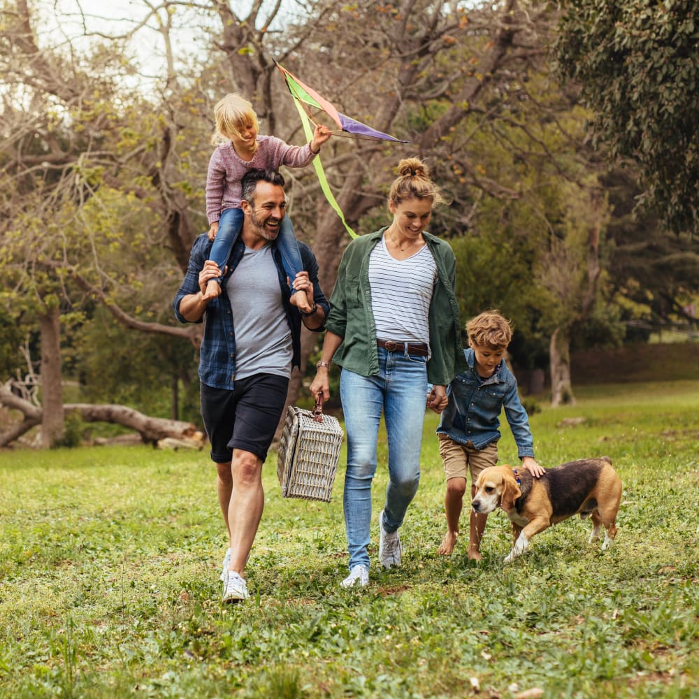 Resident family venturing out for a picnic in one of our community's green spaces at Olympus Property in Fort Worth, Texas