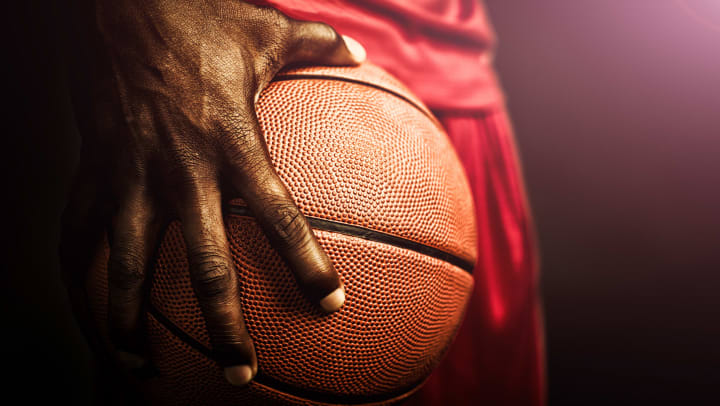 Close-up of a hand gripping a basketball