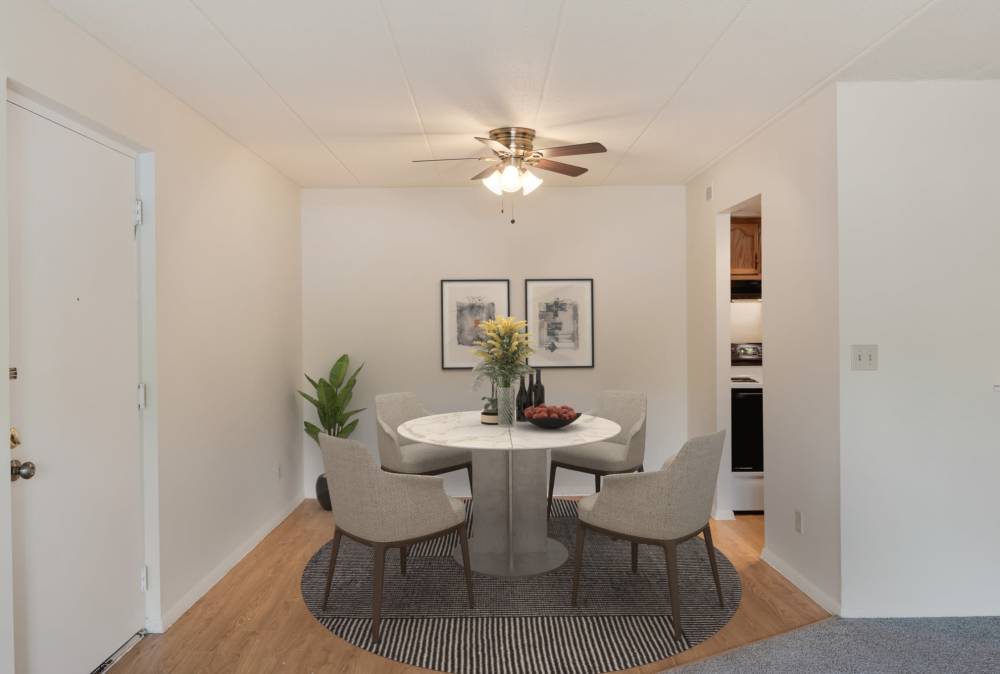 View of the bright dining room and the kitchen at Vantage Pointe West Apartment Homes in Cincinnati, Ohio