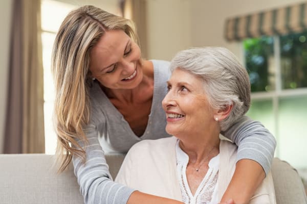 A young woman hugging a resident at Harmony Senior Services in Charleston, South Carolina