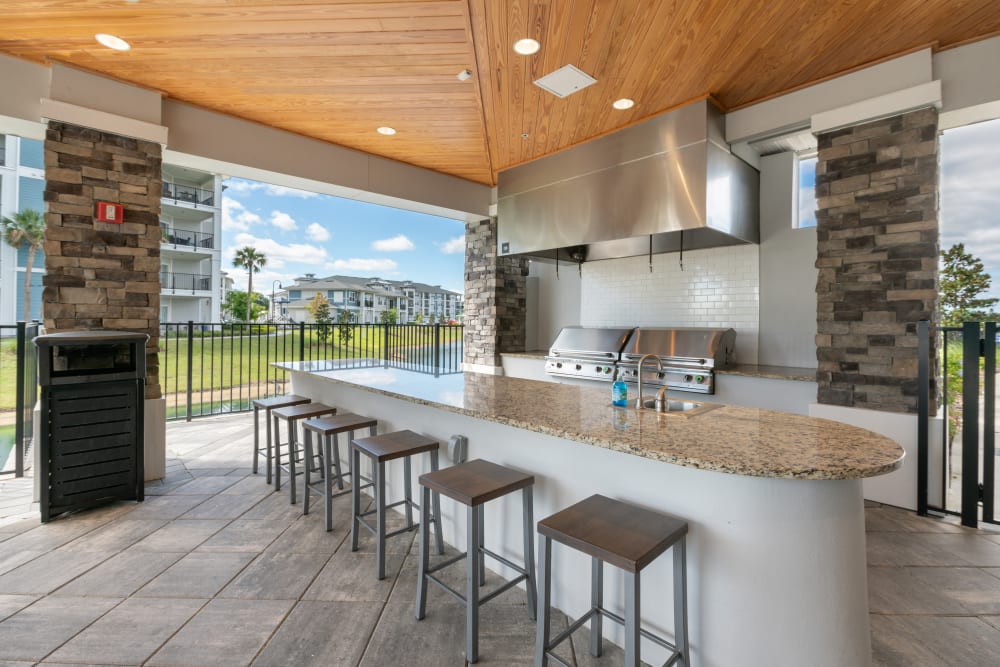 Outdoor grill and kitchen for residents at Champions Vue Apartments in Davenport, Florida