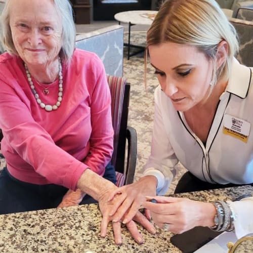 Resident having her nails done by a team member at Oxford Villa Active Senior Apartments in Wichita, Kansas