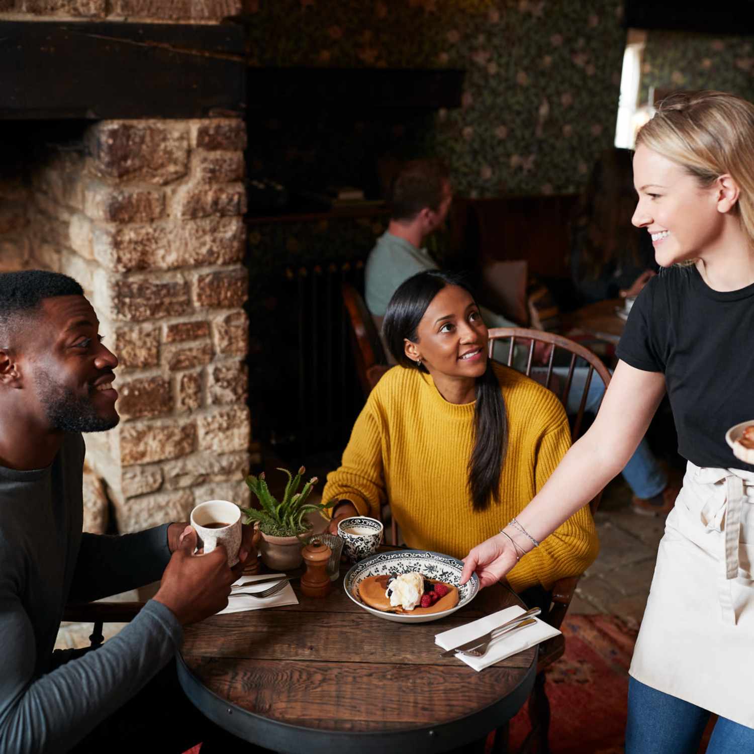 A couple being served at a restaurant near Arbors at Cahaba River in Birmingham, Alabama