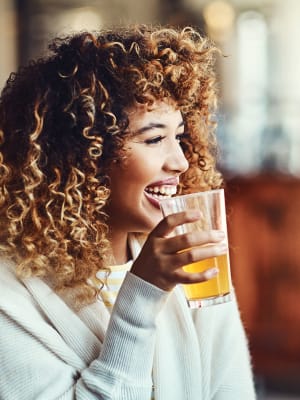 A woman enjoying a craft beer at a brewery near M2 Apartments in Denver, Colorado