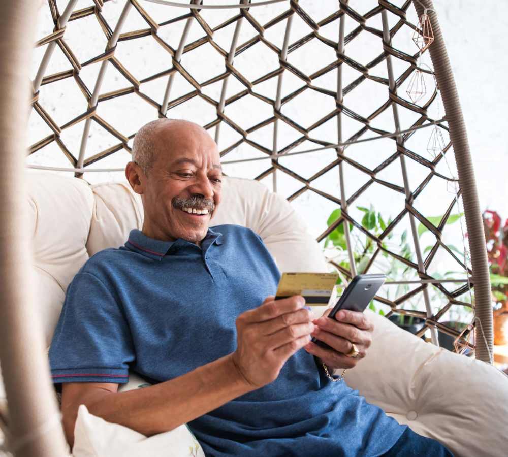 Resident reading book in his swing at Vintage at Redfield in Reno, Nevada