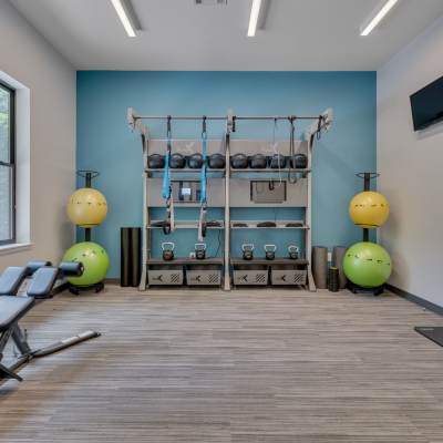 Community fitness center with various equipment at The Retreat at Lake Johnson Apartments, Raleigh, North Carolina