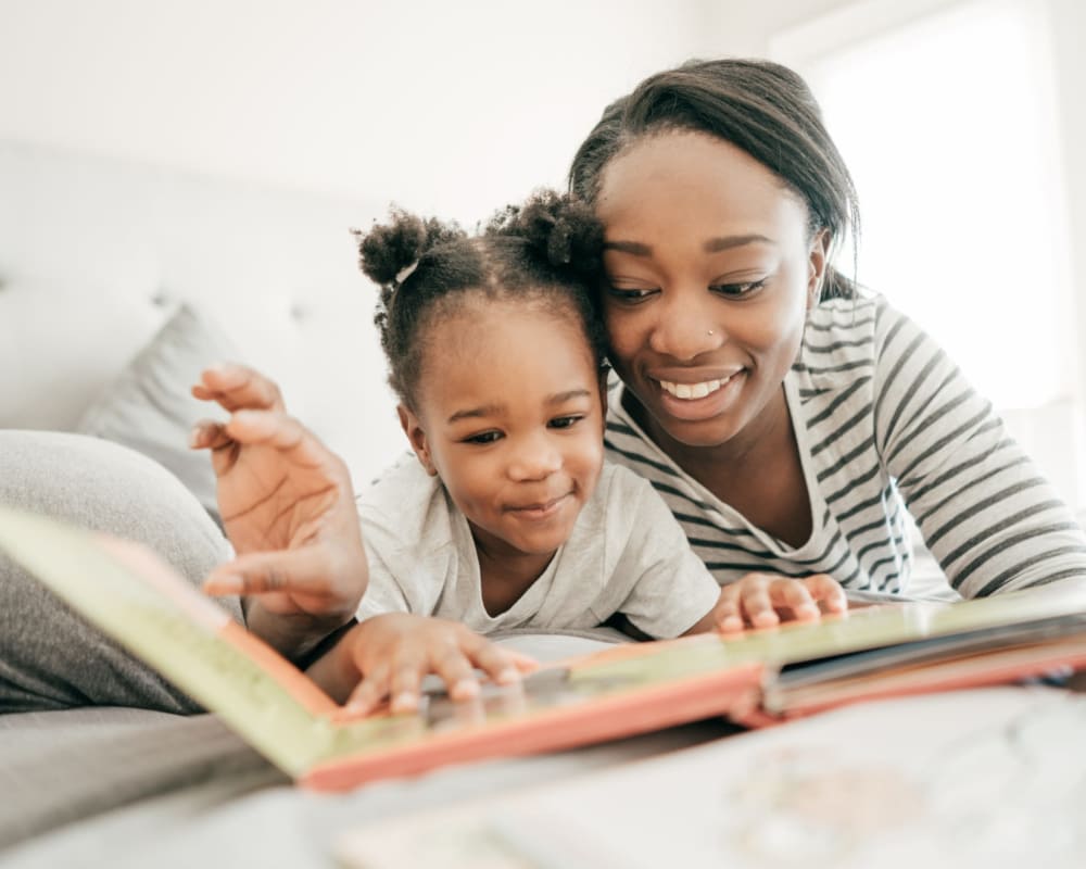 A mother teaching her daughter to read at Heartwood in Joint Base Lewis McChord, Washington