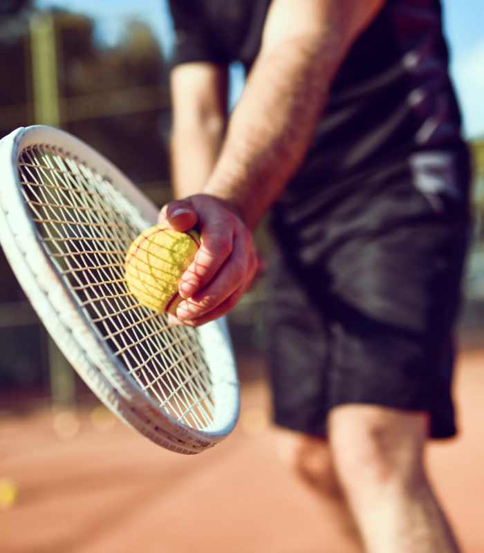 A resident playing tennis at Ascent Apartment Homes in Asheville, North Carolina