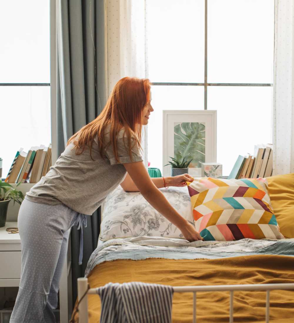 Student carefully arranged her pillow on the bed at Midtown 905 in Denton, Texas