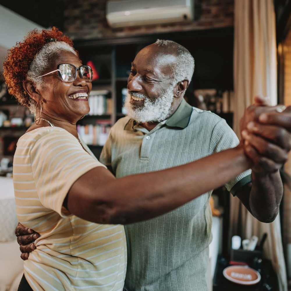 Elderly couple dancing in his living room at Bramblewood in New Haven, Michigan
