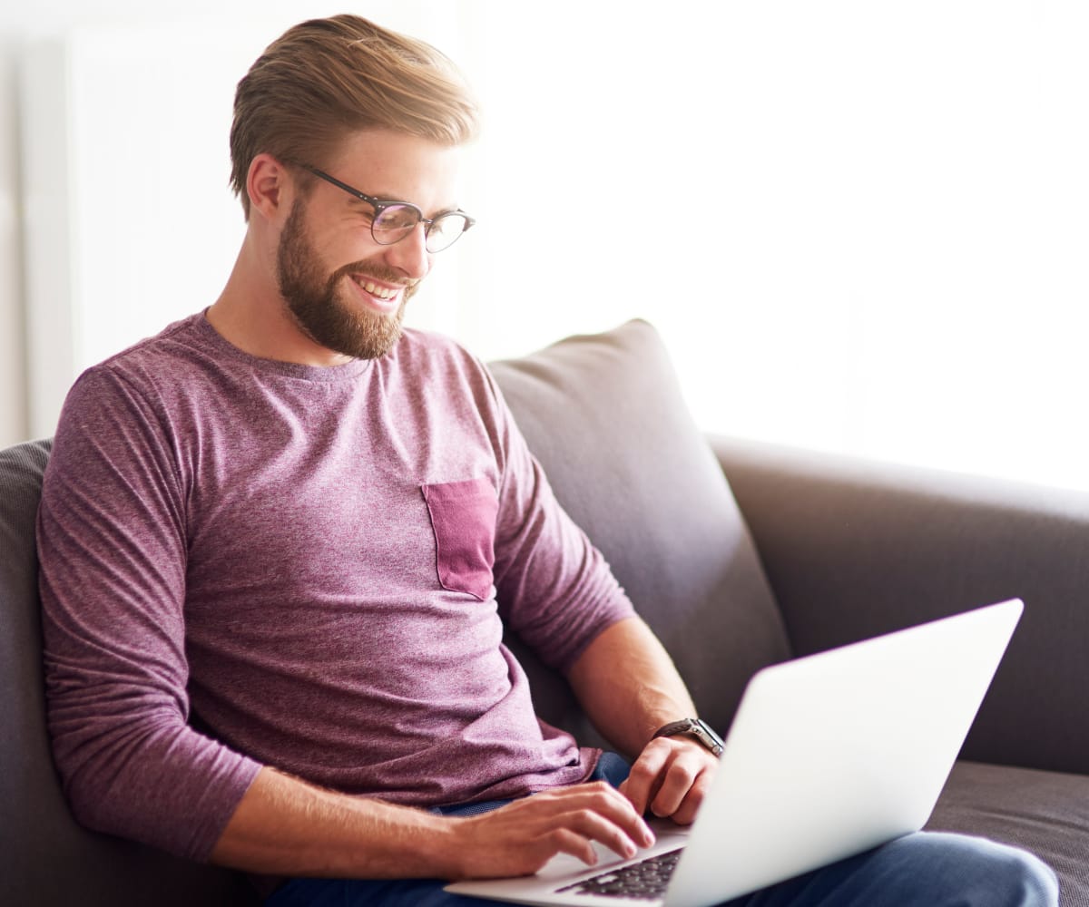Man browsing the internet at Portofino Apartments in Wichita, Kansas