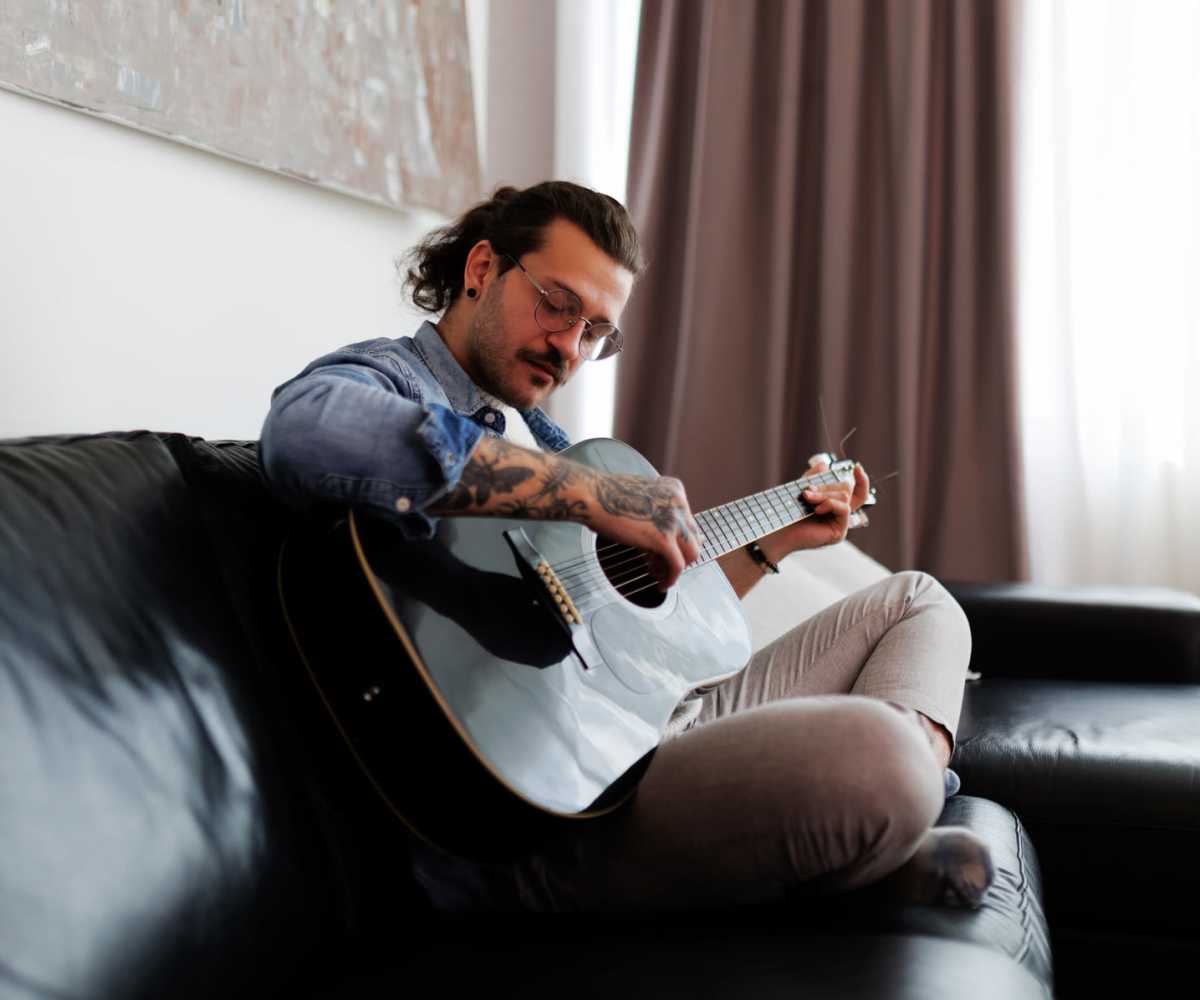  A resident playing guitar in his apartment home near Forsythia Court Apartments in Abingdon, Maryland