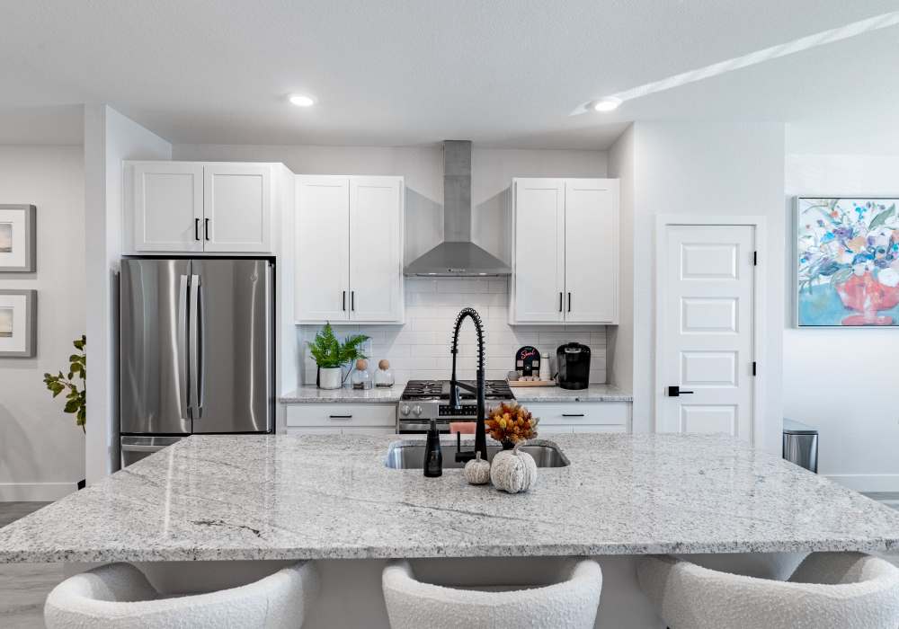 Kitchen featuring island and upgraded appliances 