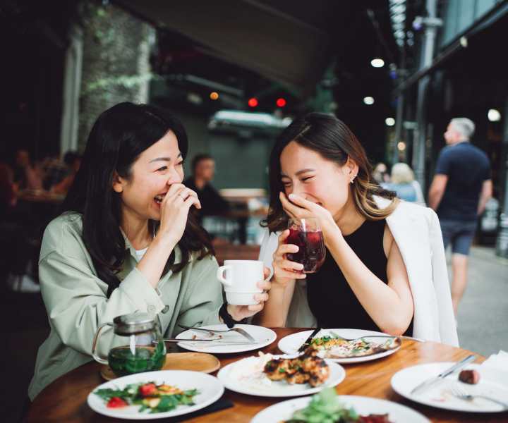 Friends enjoying a meal in a restaurant near The Brighton in Houston, Texas 