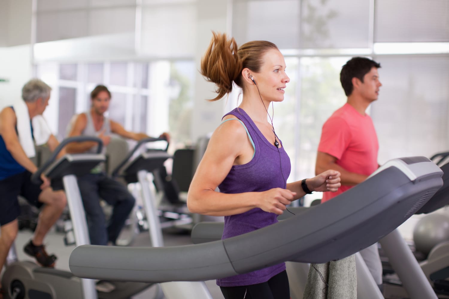 Woman working out in the resident fitness center at The Pines at Castle Rock Apartments in Castle Rock, Colorado