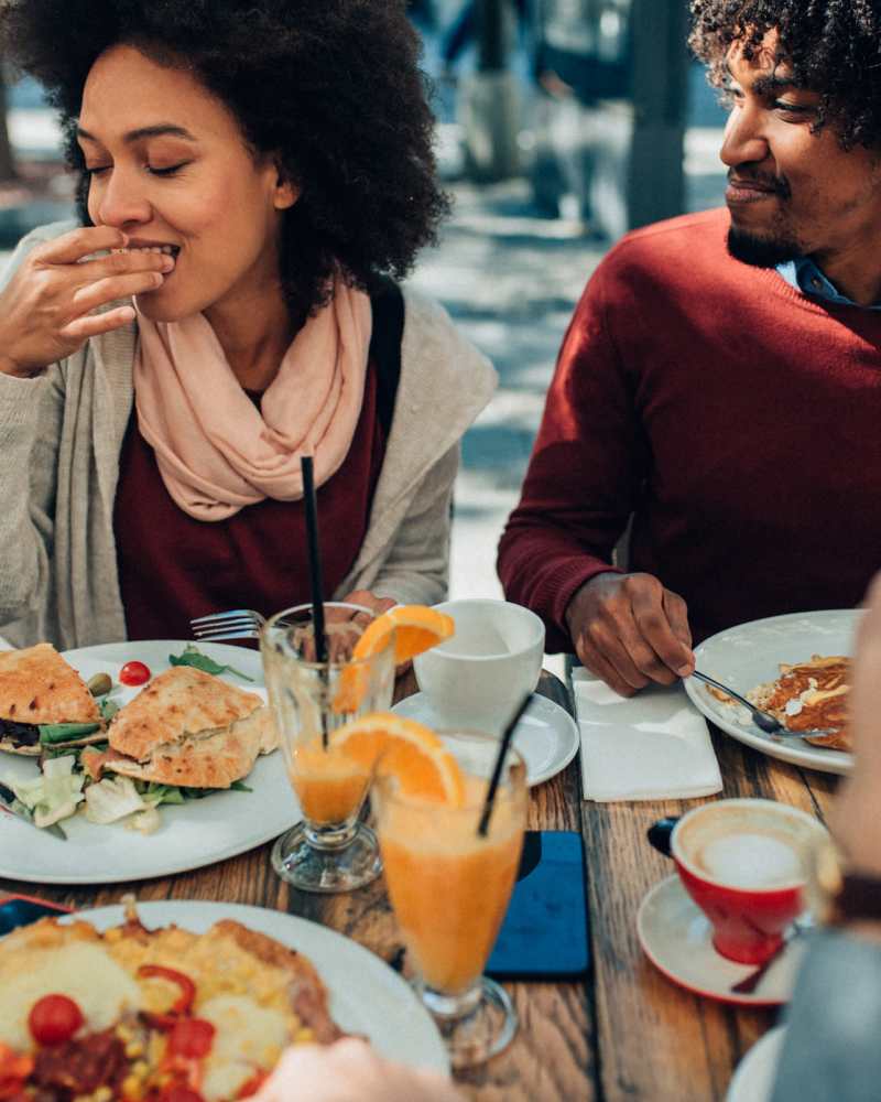 Residents enjoying their food in a nearby restaurant at Vivo Living Summerville in Summerville, South Carolina