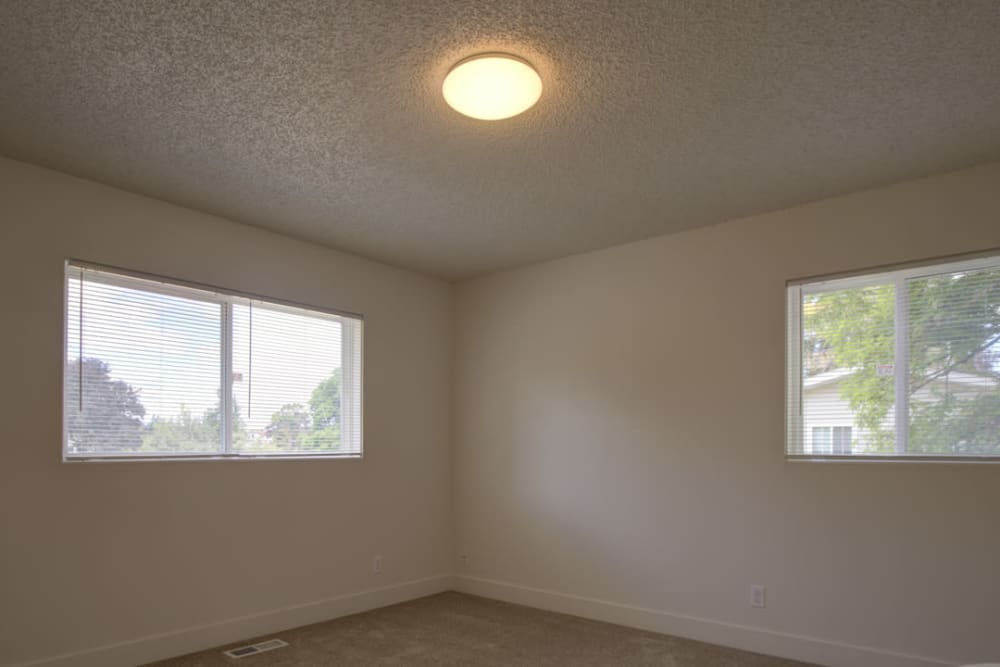 A bedroom with bright windows at Clarkdale in Joint Base Lewis McChord, Washington