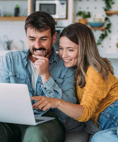 A couple looking at their computer at Gateway Plaza Apartments in Portland, Oregon
