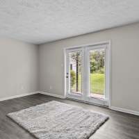 Living room with balcony access at Commodore in Vicksburg, Mississippi