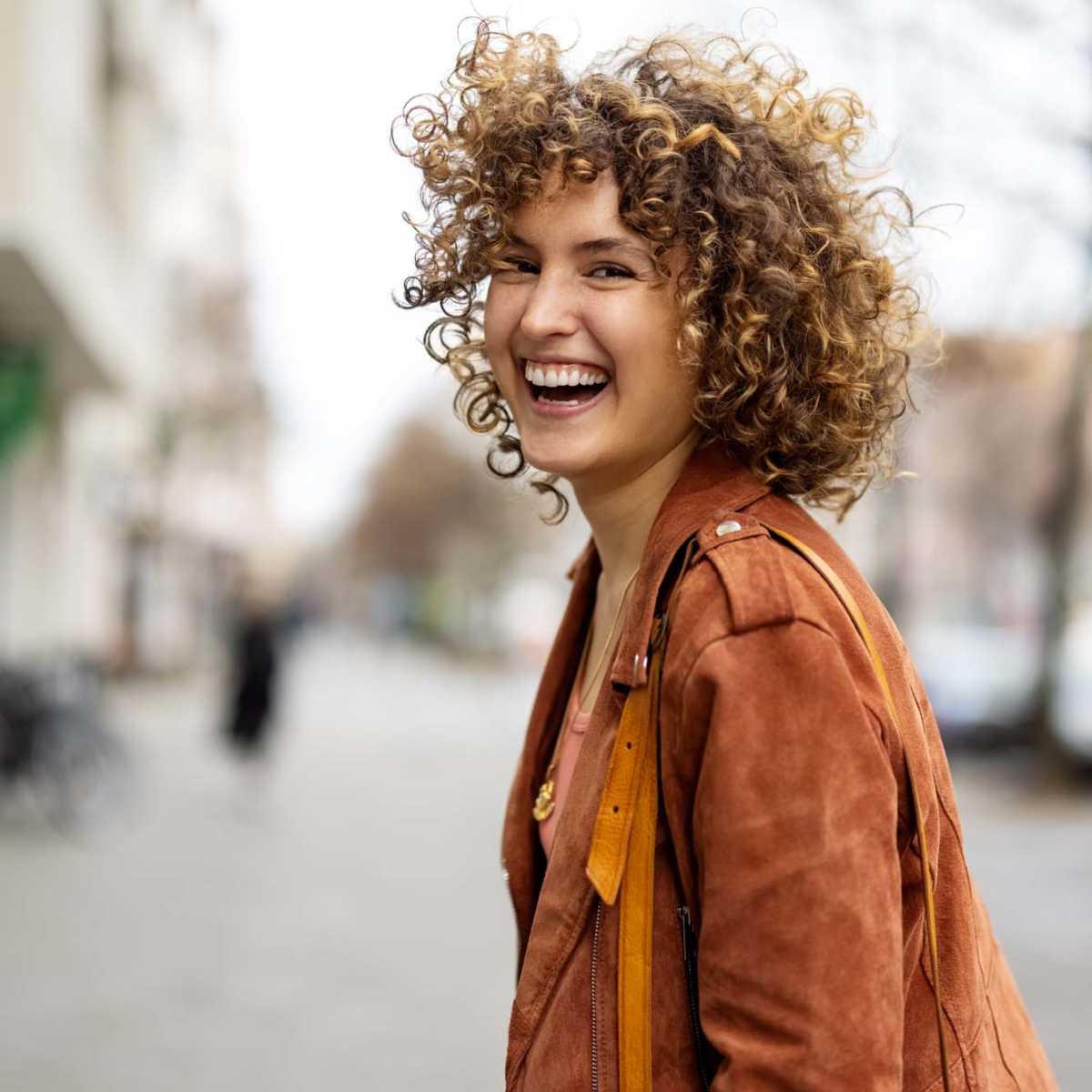 Resident smiling over her shoulder while walking near Encore at Westgate in Leland, North Carolina