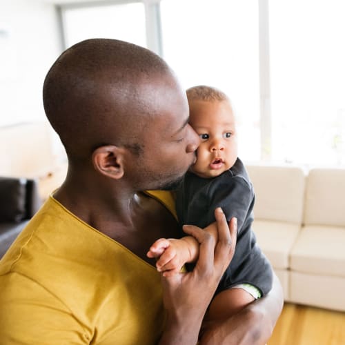 Resident holding child at Heroes Manor in Camp Lejeune, North Carolina