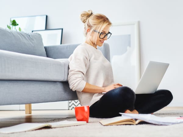 Resident working on her laptop in her luxury home at Harrison Tower in Portland, Oregon