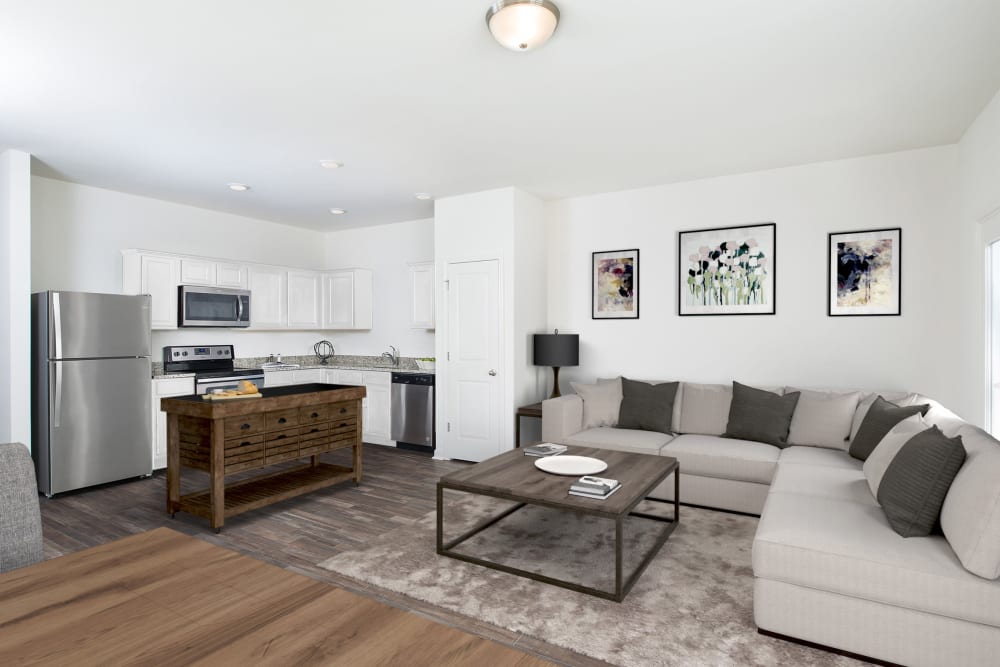 A rendering of a living room layout with kitchen at Artisan Living Bella Citta in Davenport, Florida
