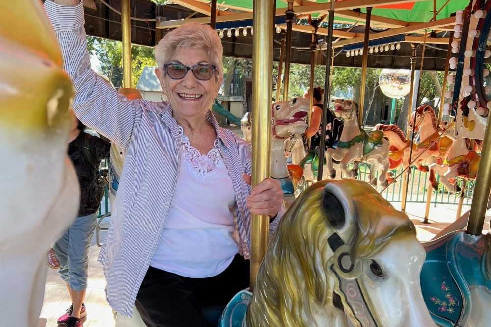 Resident having fun on a carousel Ray Stone Inc. in Sacramento, California