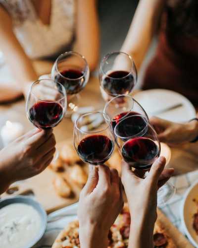 Residents enjoying food and drinks at a restaurant near Creekside Villas at Clear Lake Apartments in Houston, Texas