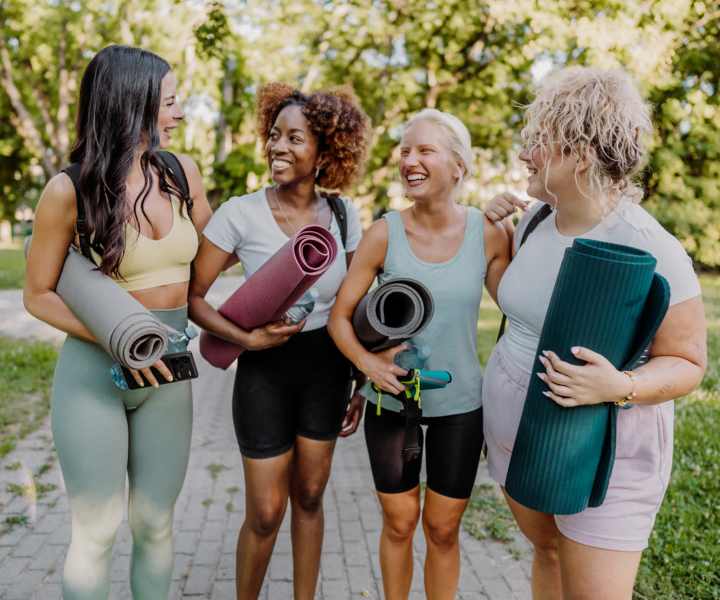Women in a park holding yoga mats near Sunset Bay Apartments in Cutler Bay, Florida