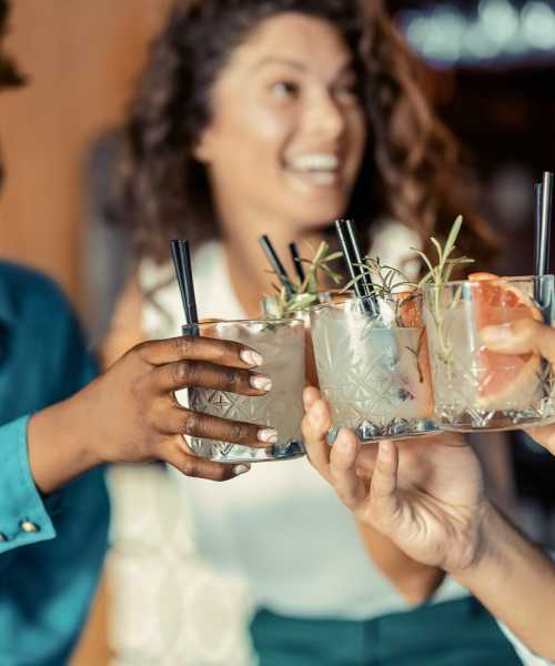 Friends raising a toast near The Olivia in Homestead, Florida