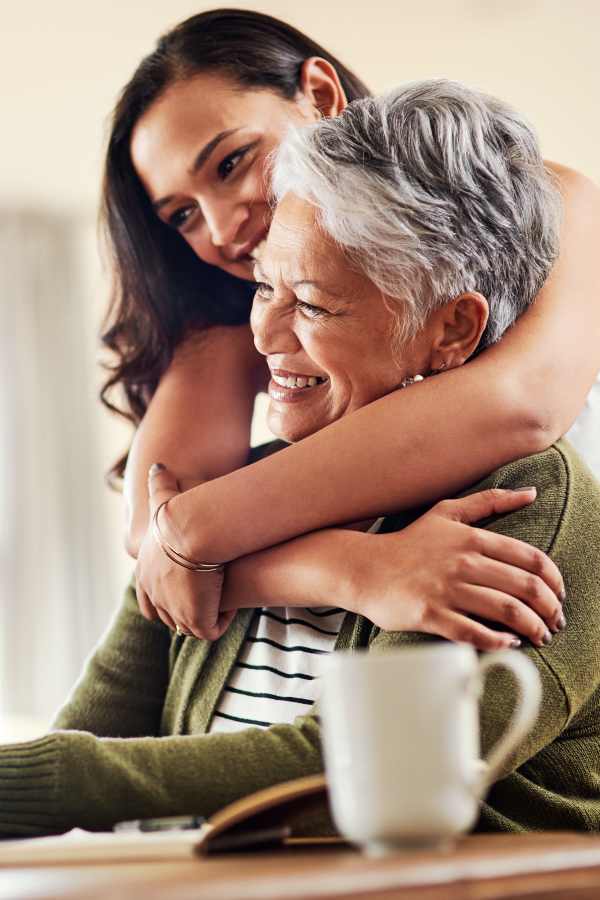 Resident mother and daughter embracing at Truewood by Merrill, Boise in Boise, Idaho