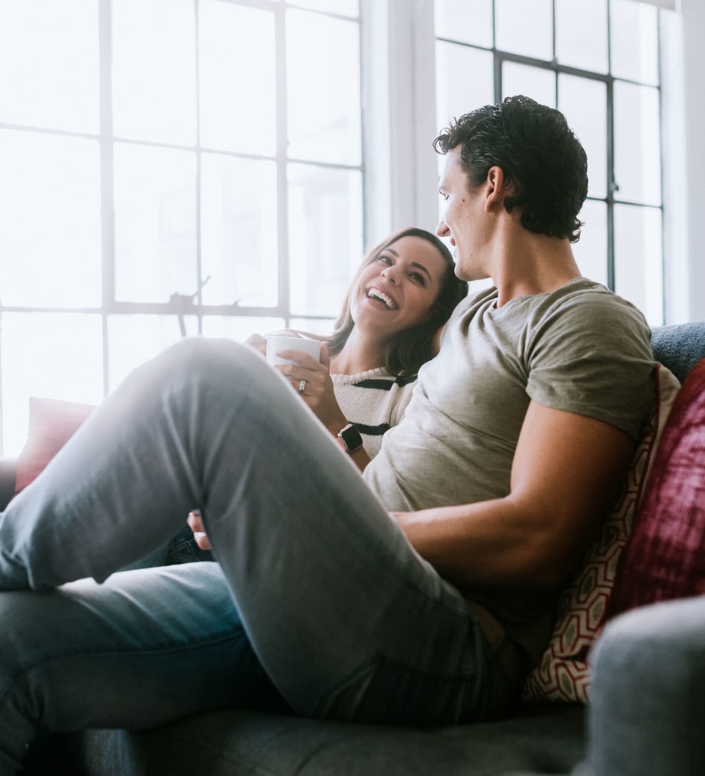 Residents relaxing on their couch at Crimson in Tuscaloosa, Alabama
