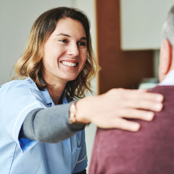 Resident speaking to staff at Pacifica Senior Living Hillsborough in Chino, California.