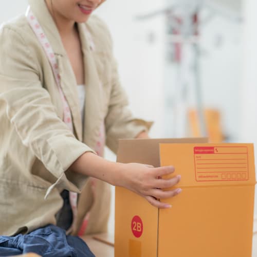 A customer packing a box near Red Dot Storage in Kingwood, Texas