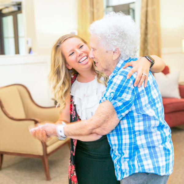 Resident dancing with staff at The Castlewood Senior Living in Nixa, Missouri