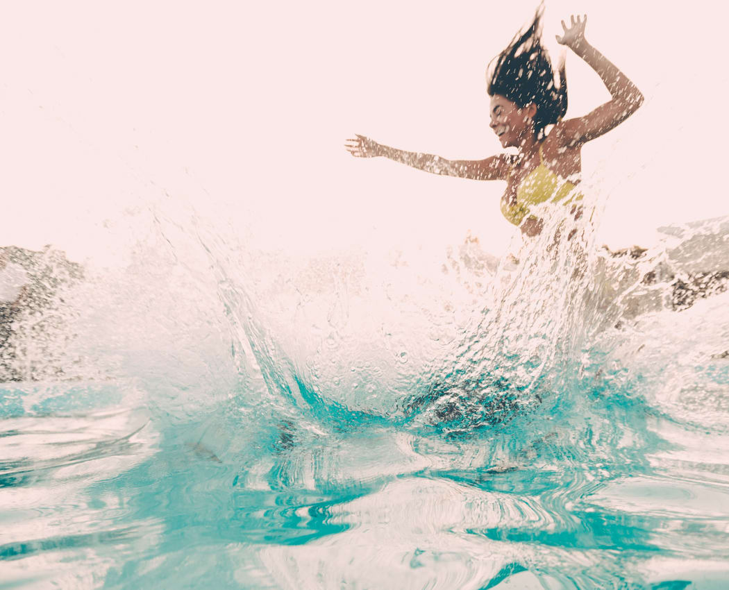 Resident jumping into the pool at The Remington Apartments in Wichita, Kansas