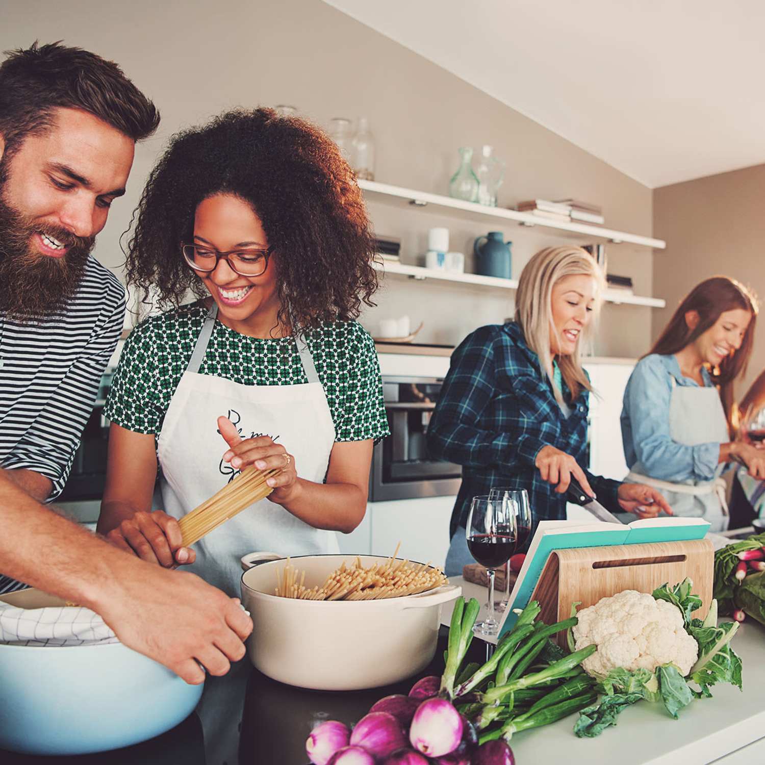 A group of friends cooking in their apartment at Arbors at Cahaba River in Birmingham, Alabama