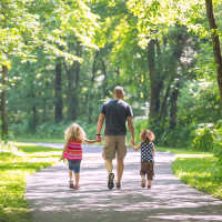 Resident and his children walking along the park near Chandler At University Tower in Durham, North Carolina