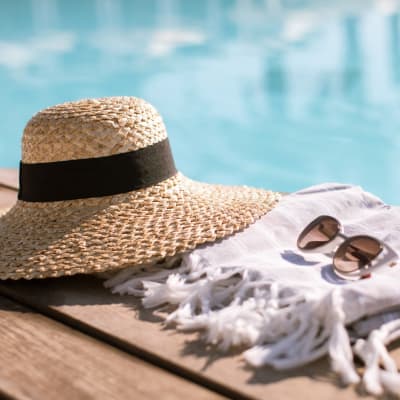 Sunglasses and hat next to pool at Santa Rosa in Point Mugu, California