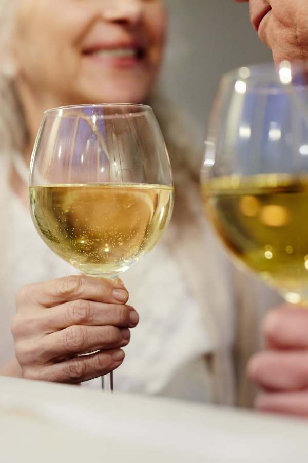Resident couple enjoying a glass of wine at Truewood by Merrill, Glen Riddle in Glen Riddle, Pennsylvania
