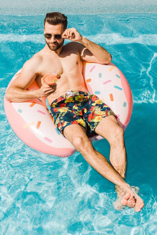 Resident relaxing in the pool at Crescent Apartments in Roseville, California