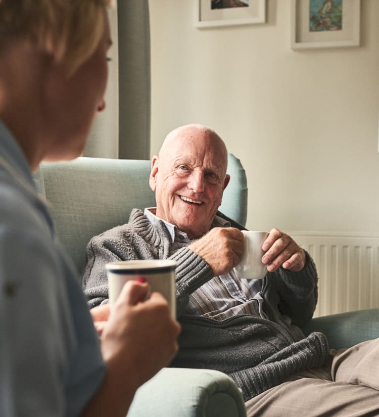 Resident and caregiver talking at Monark Grove Clarkston in Clarkston, Michigan