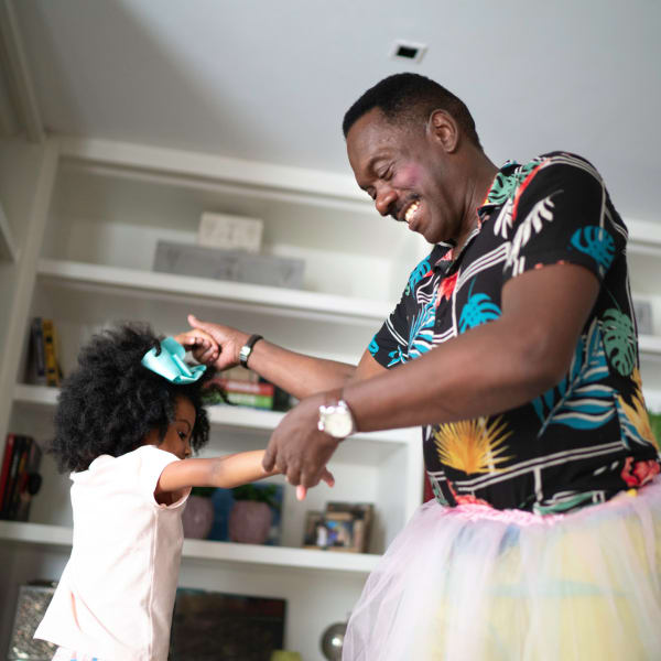 A man and his granddaughter play dress up at Monte Vista Village in Lemon Grove, California
