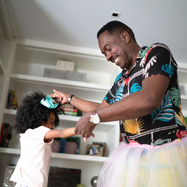 A man and his granddaughter play dress up at Tampa Gardens Senior Living in Tampa, Florida