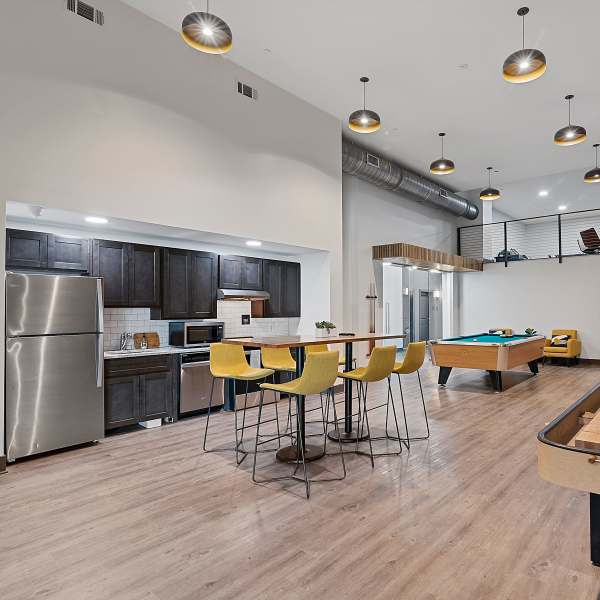 Community ktichen wtih dining area and pool table at The Lofts at the Municipal in Lafayette, Louisiana