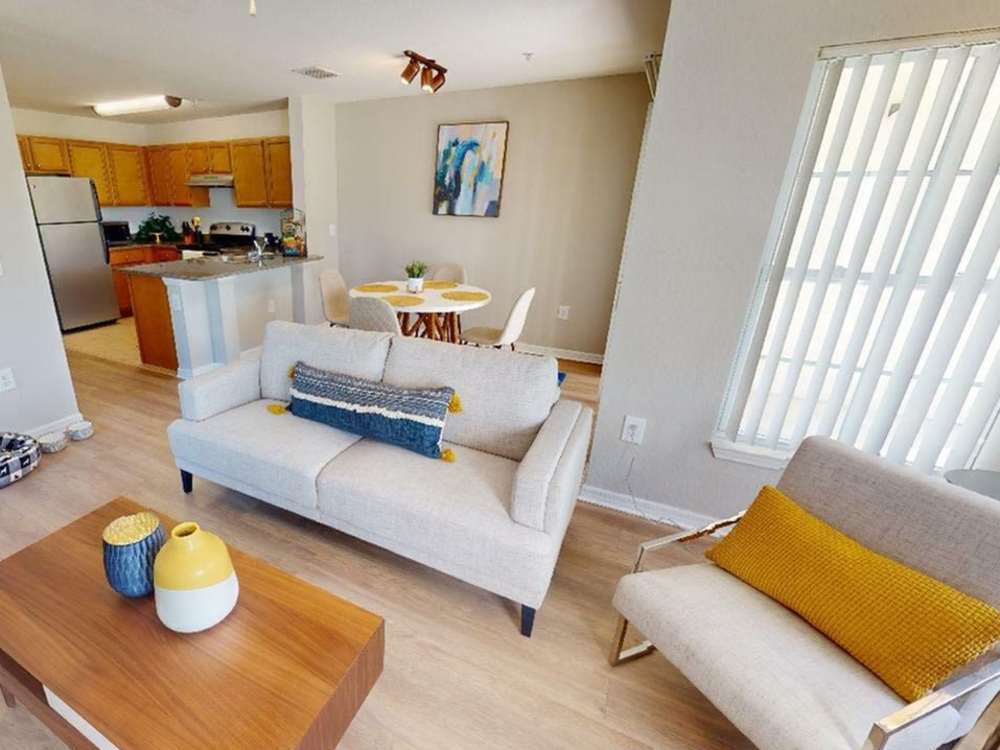 Living room with view to kitchen atThe Reserve at Brookhaven in Palm Coast, 