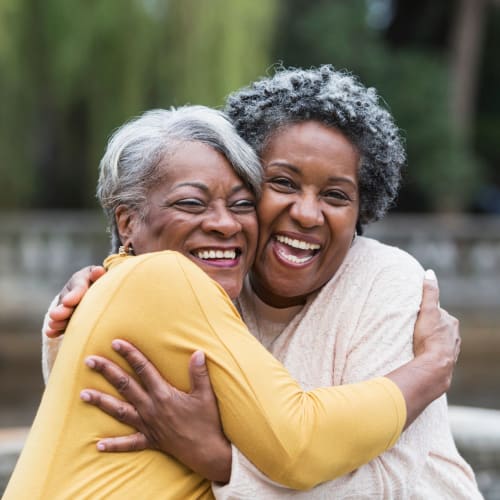 Two residents hugging at The Crossings at Eastchase in Montgomery, Alabama