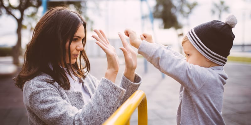 A woman playing with her child at a school playground near Chesterton in San Diego, California