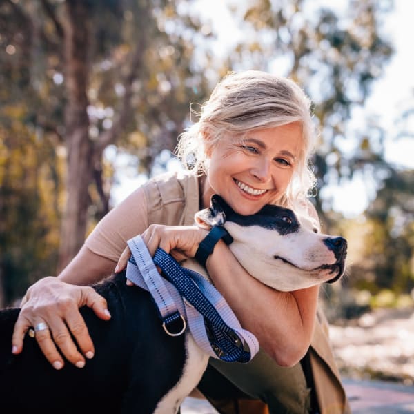 Resident giving her dog some love on a walk near Hickory Hollow in Spencerport, New York